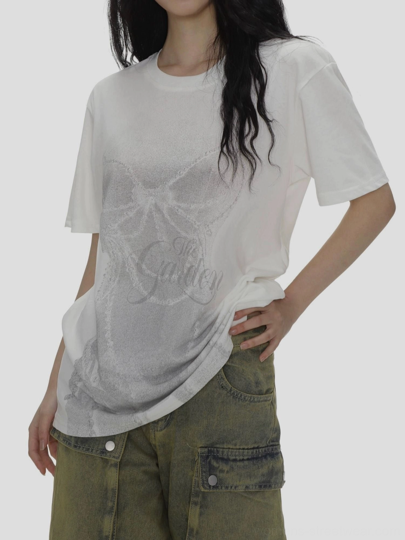 Close-up of white crew neck T-shirt with feminine bow and cursive front graphic print