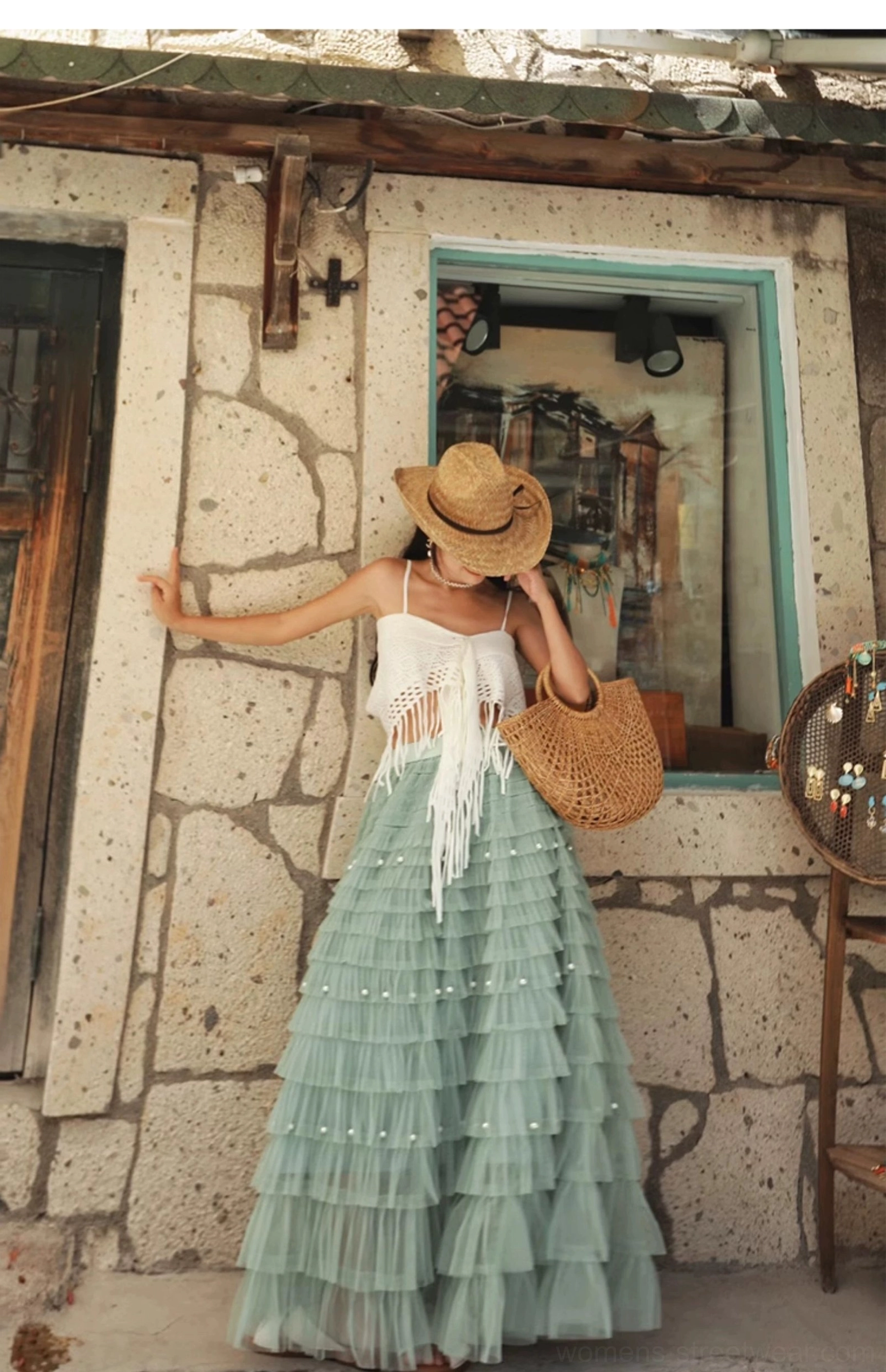 White crochet fringe top with spaghetti straps and a tiered sage green maxi skirt styled with a woven tote