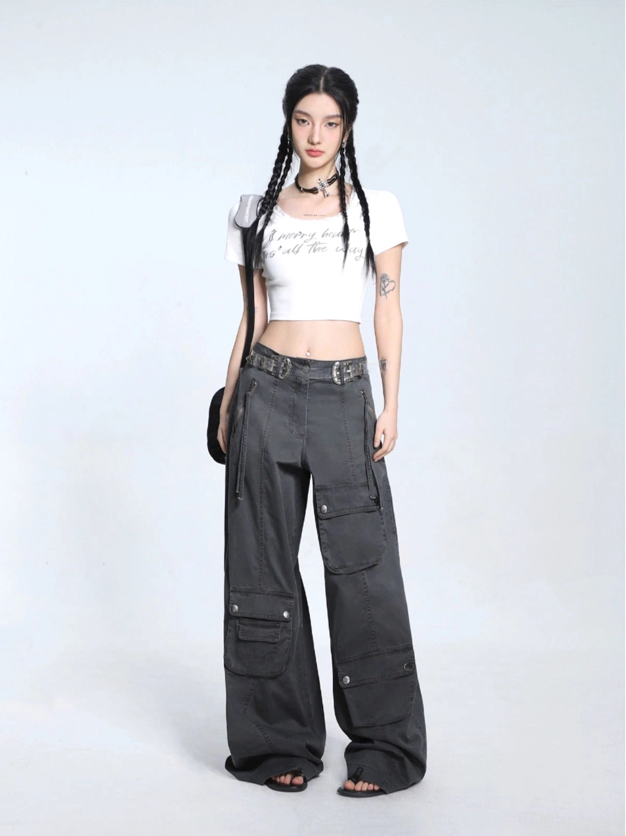 White cropped short sleeve graphic T-shirt with delicate lace neckline paired with utility cargo pants and black handbag