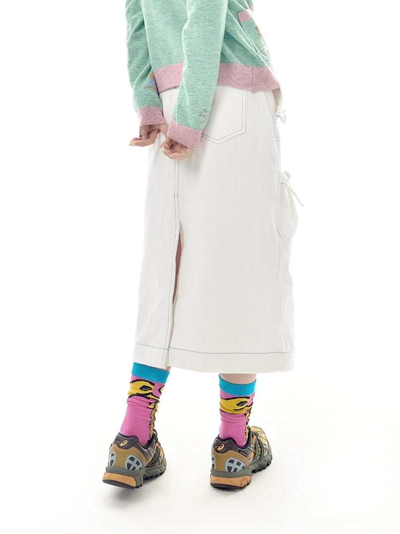 White denim utility pocket midi skirt back three-quarter model view showing drawstring pockets and back hem slit