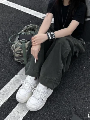 White detachable chain platform chunky sneakers styled with dark green cargo pants in streetwear outfit
