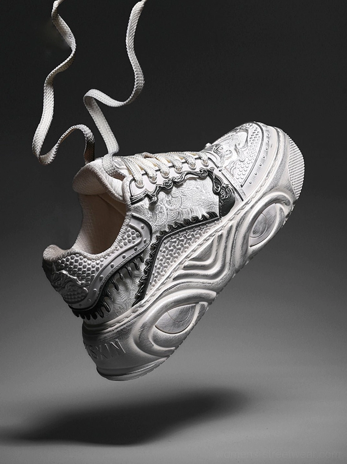 Single white distressed platform sneaker with bone-textured upper, breathable mesh heel panel, curled laces, and chunky wave sole