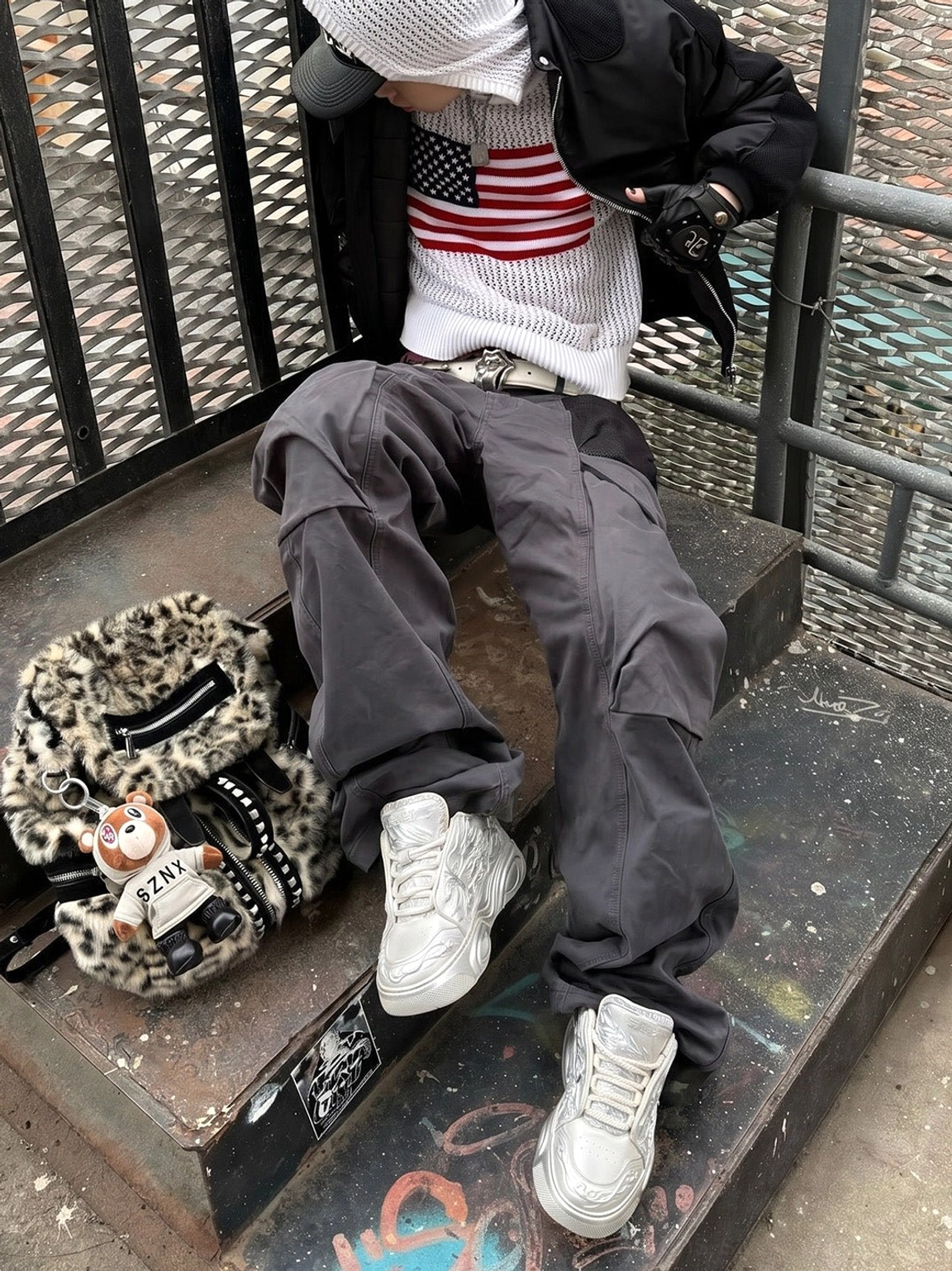 White dragon platform sneakers worn with an urban streetwear outfit in a graffiti-covered industrial stairwell