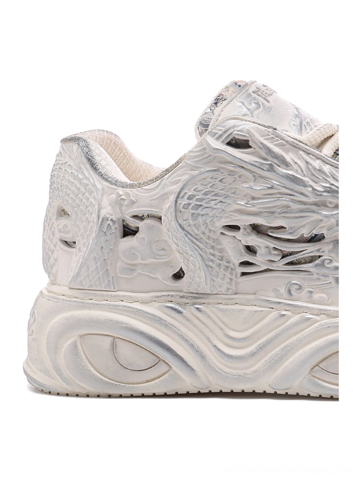 White dragon relief platform sneakers with chunky sculpted soles and tonal 3D streetwear detailing