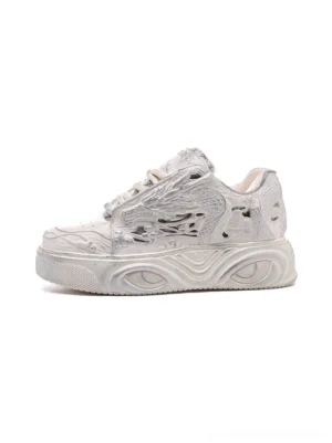 White dragon relief platform sneakers shown in a left side profile with a 3D carved upper and chunky wavy platform sole