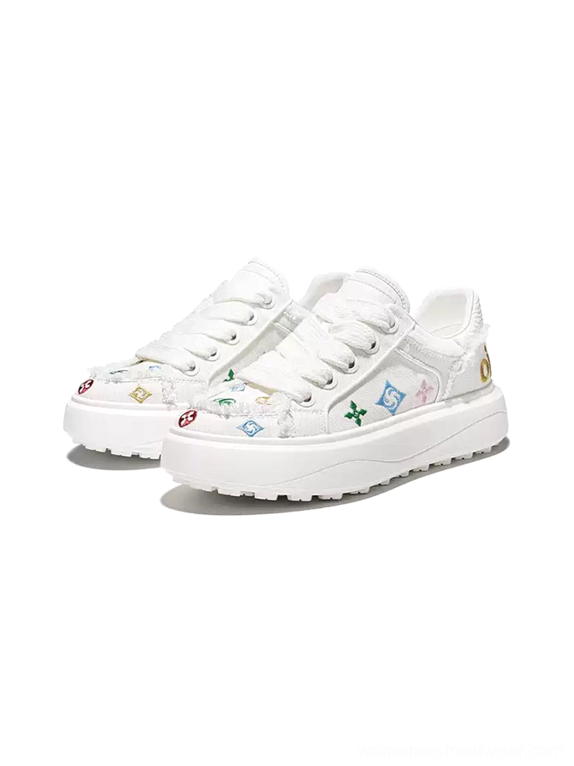 Front view pair of white embossed platform skate sneakers with colorful graphic embroidery frayed edges and thick sole