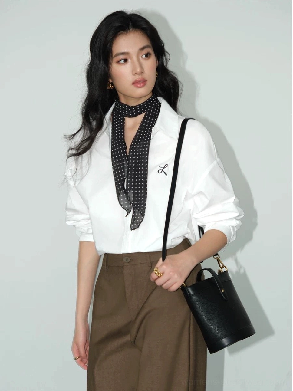 White embroidered button-down shirt styled with brown midi skirt polka dot scarf and black shoulder bag