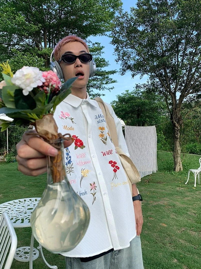 White embroidered floral waffle short sleeve shirt with colorful botanical artwork and relaxed boxy streetwear silhouette