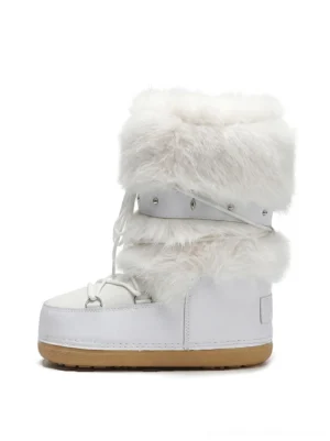 Front view of white faux fur platform snow boots with fluffy cuffs, studded straps, lace-up closure, and chunky gum rubber outsole