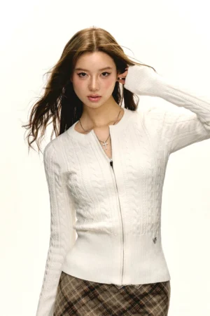 White fitted cable knit zip cardigan with round neckline, slim waist silhouette, long sleeves, ribbed cuffs, and minimalist Korean streetwear styling