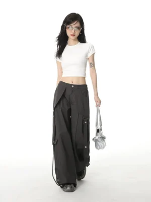 White fitted crop tee with crew neck on female model paired with black cargo pants and silver handbag full body front view streetwear styling