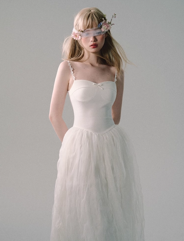 Back three-quarter view of white floor-length tulle gown with lace-trimmed straps, fitted waist, and flowing A-line skirt