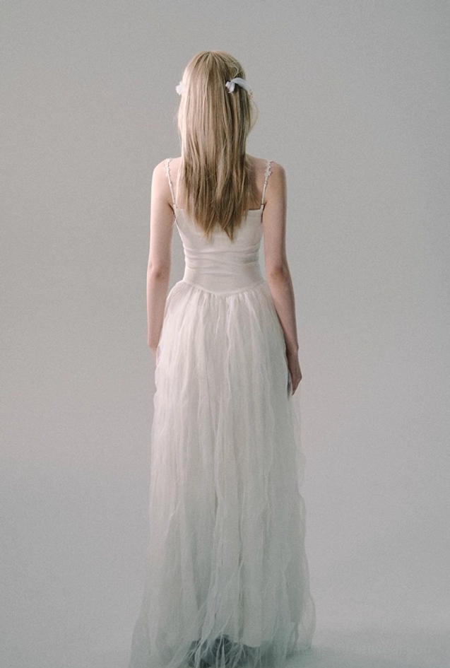 White floor-length tulle gown with delicate lace straps and fitted sweetheart bodice for romantic bridal and formalwear styling