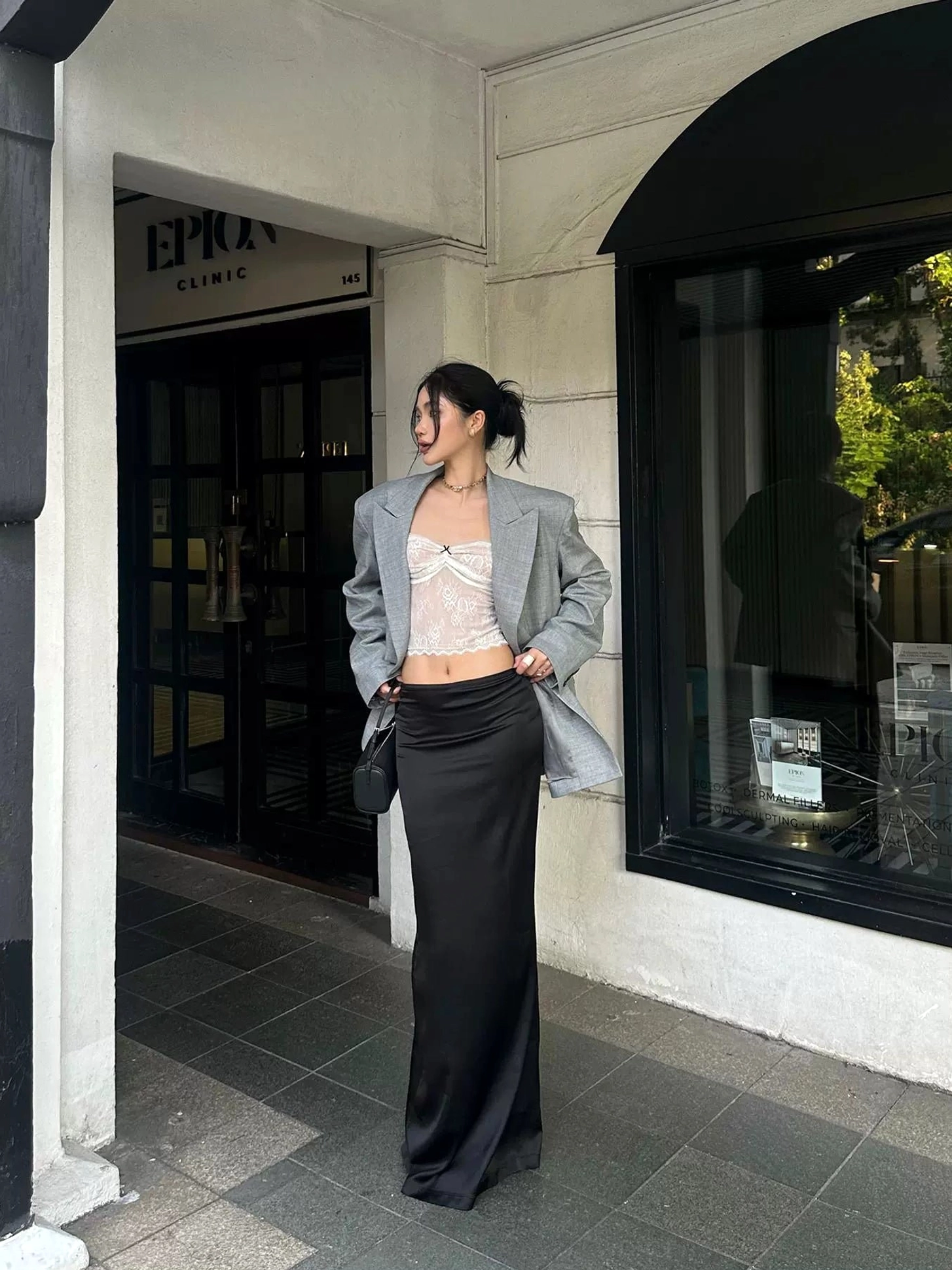 White floral lace mesh cami top styled with a grey blazer and black satin maxi skirt in a contemporary Seoul-inspired streetwear outfit