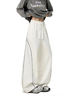 White Flower Gray oatmeal heather oversized balloon sweatpants with wide leg silhouette, drawstring elastic waist, contrast seam stitching, and retro sneaker streetwear styling