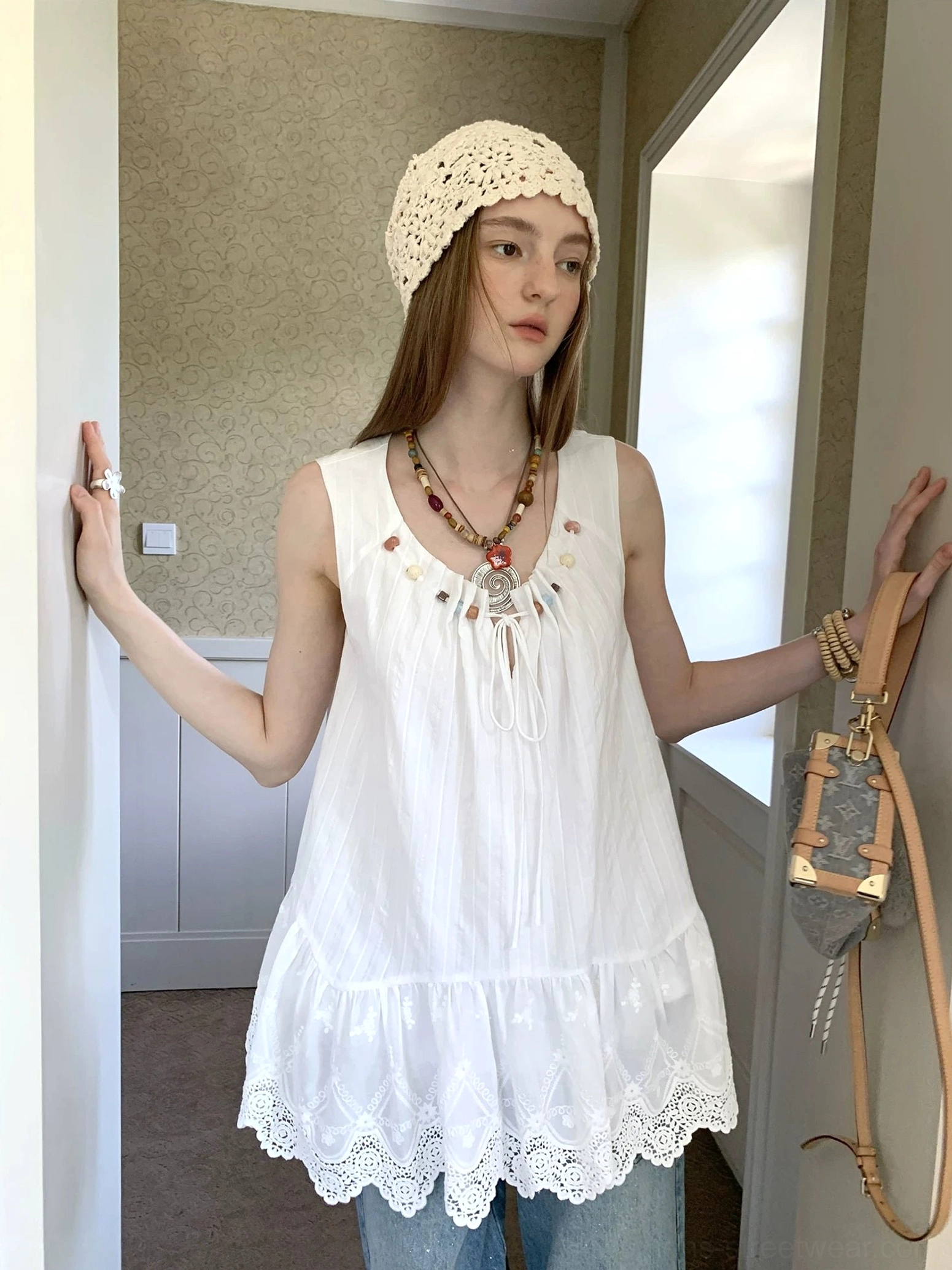 Flowy white sleeveless boho tunic top with beaded drawstring neckline and scalloped embroidered eyelet lace hem