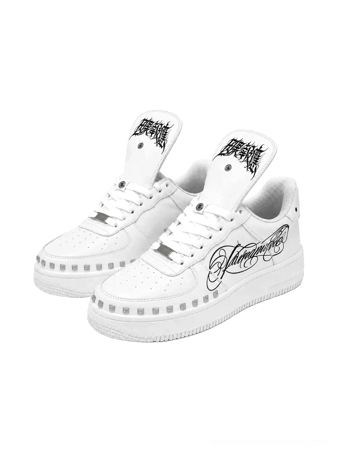 White foldover tongue chunky leather sneakers with gothic script, cursive side artwork, perforated toe box and decorative studded midsole