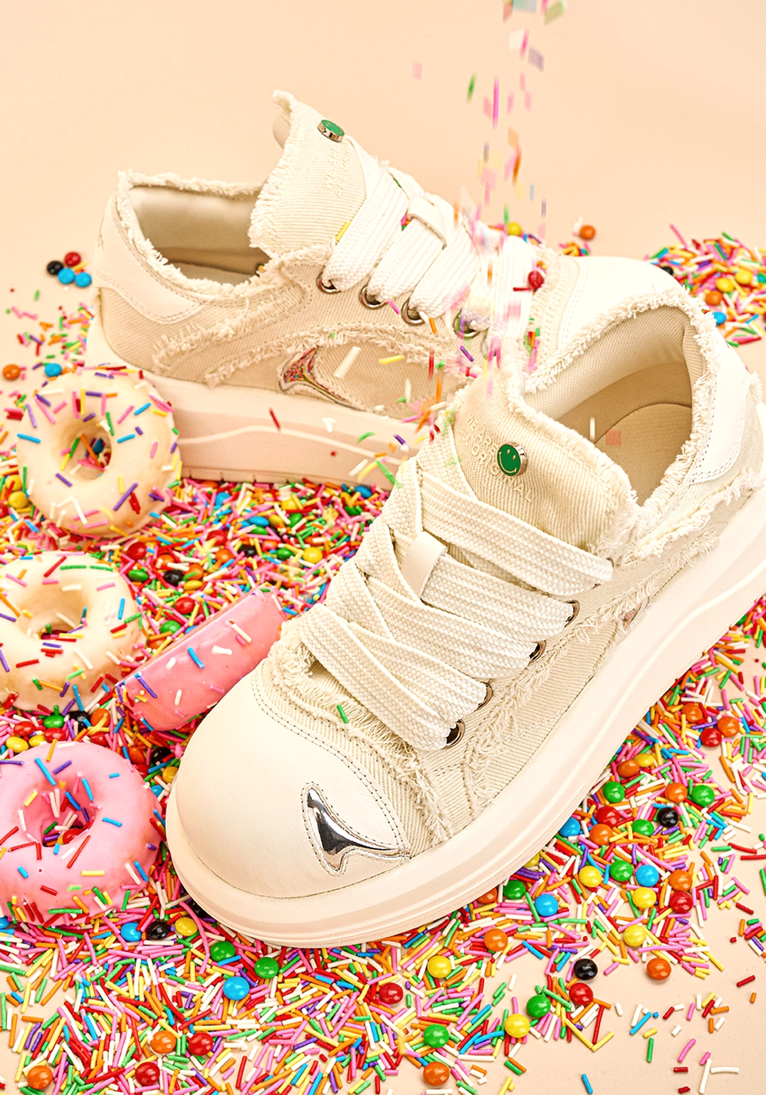Pair of white frayed canvas platform skate sneakers with chunky white soles and wide streetwear laces