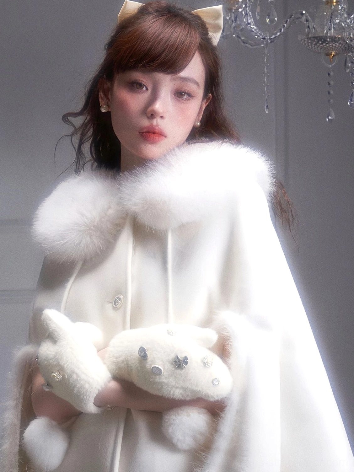 Close-up of white fur collar cape coat highlighting soft plush neckline smooth fabric and front button details