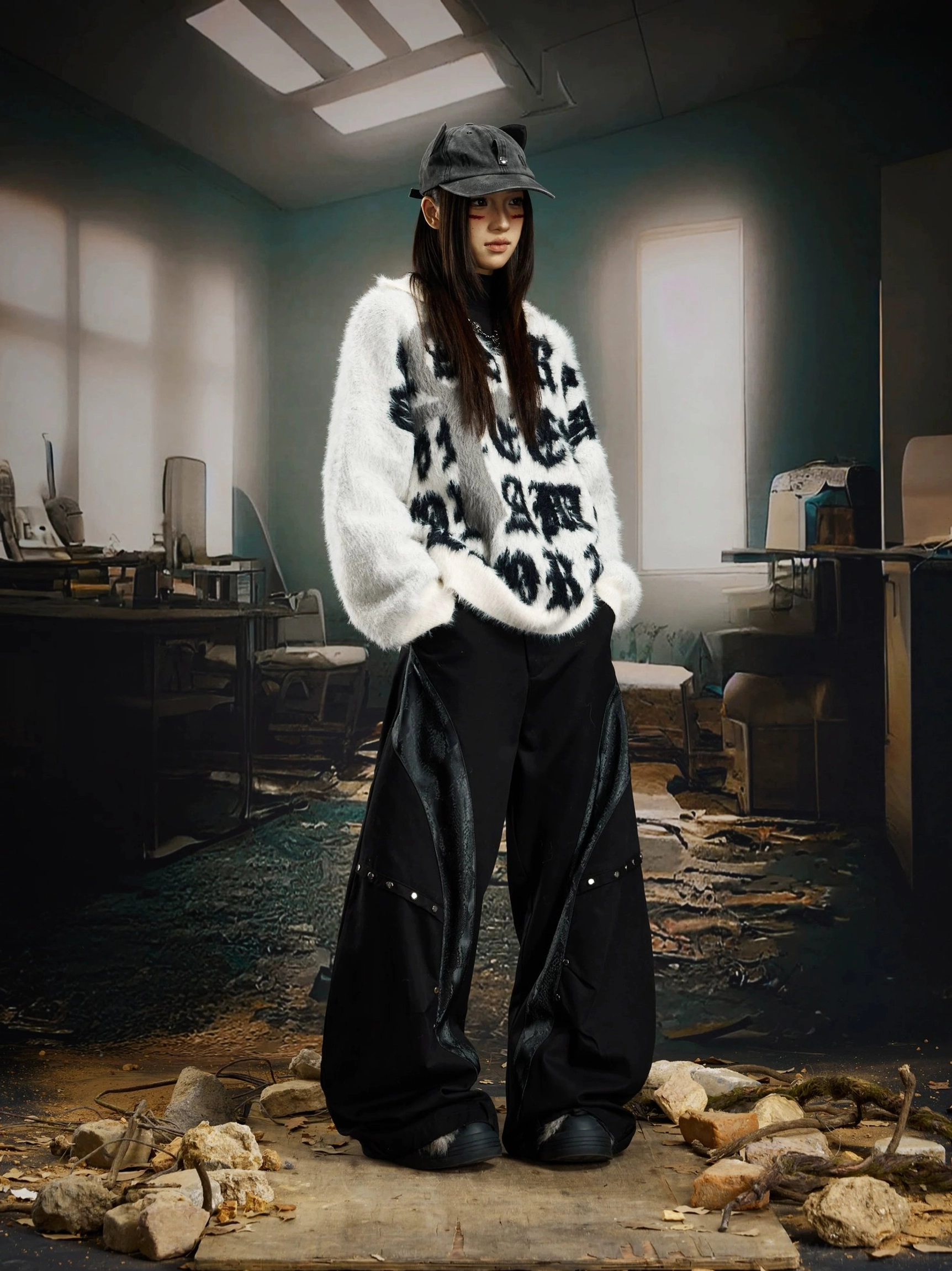 White oversized fuzzy jacquard sweater with bold black gothic typography styled with black wide leg pants and a bucket hat