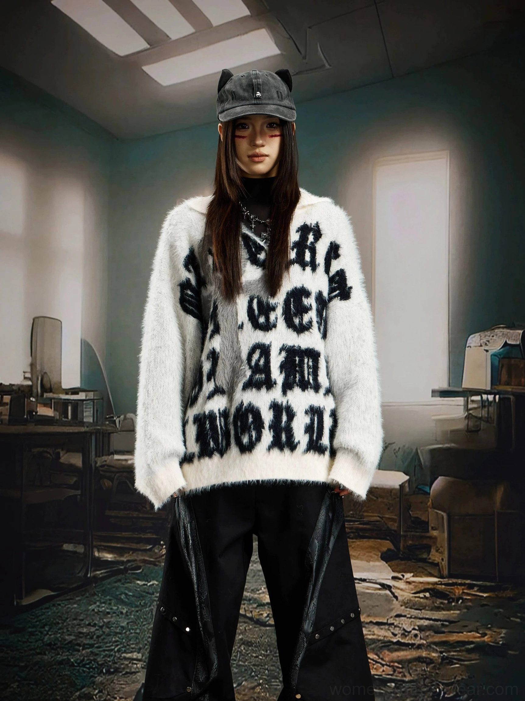 White fuzzy gothic sweater with cross motif and black lettering styled on a female model with a cat ear bucket hat
