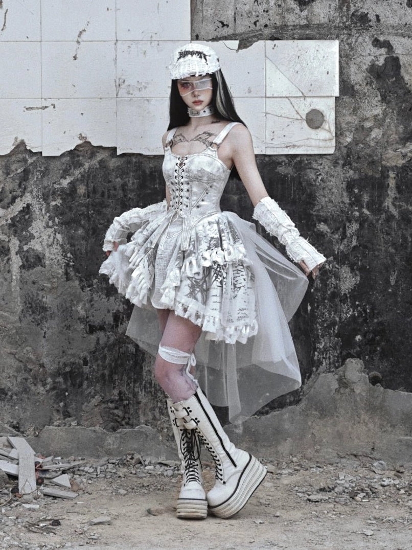 Side three-quarter view of white gothic high-low corset dress with ruffled skirt and flowing sheer tulle train