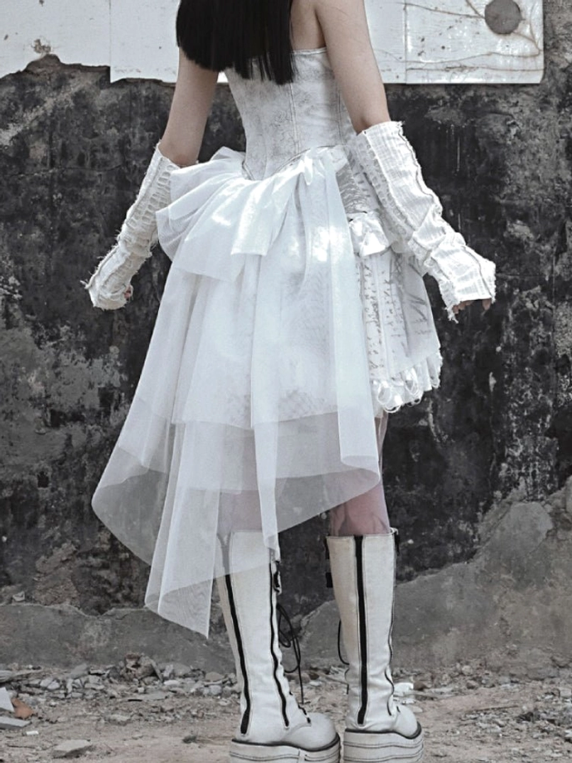 White gothic lace-up corset high-low dress with layered ruffles and dramatic sheer tulle back detail