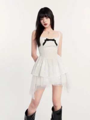 White gothic Lolita mini dress with black velvet bust bow, sweetheart neckline, fitted bodice, and sheer layered tulle skirt