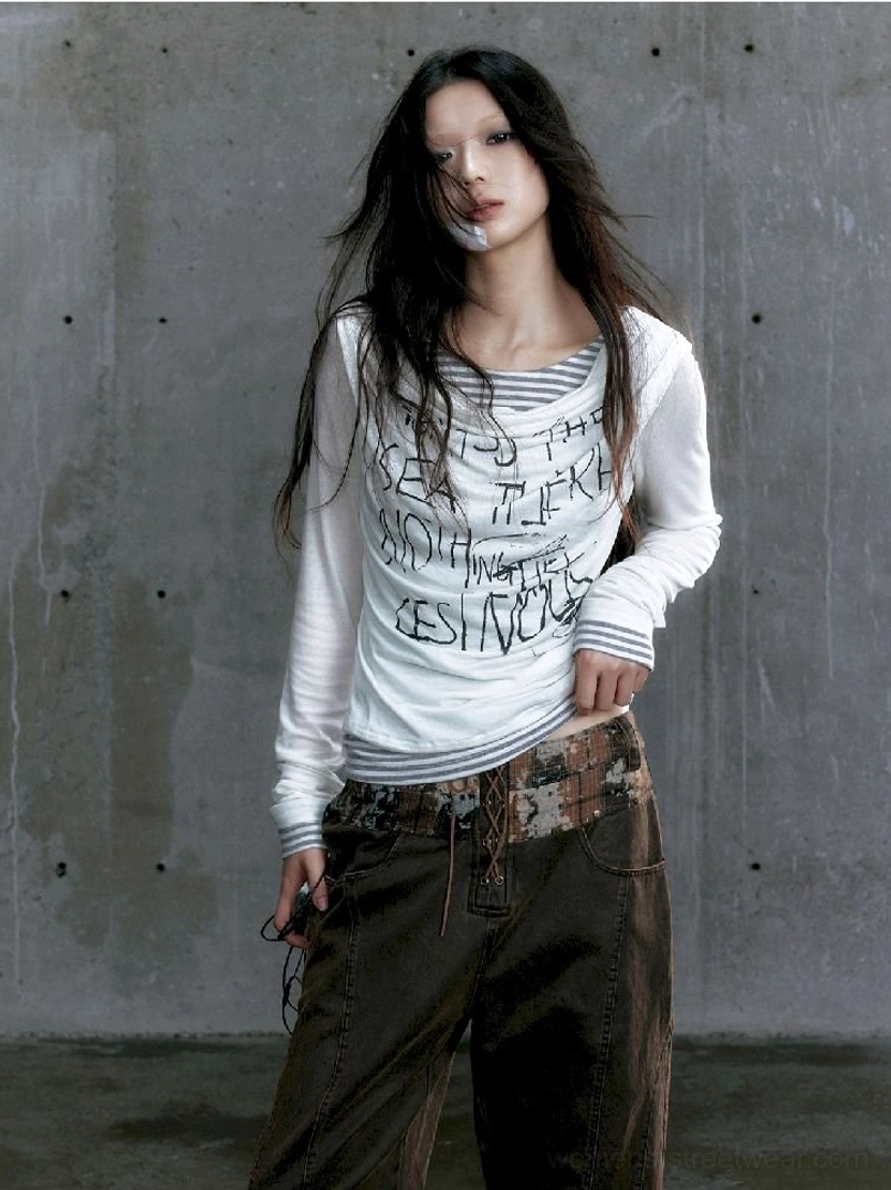 White graffiti layered long sleeve top paired with cargo pants in a full body urban streetwear outfit