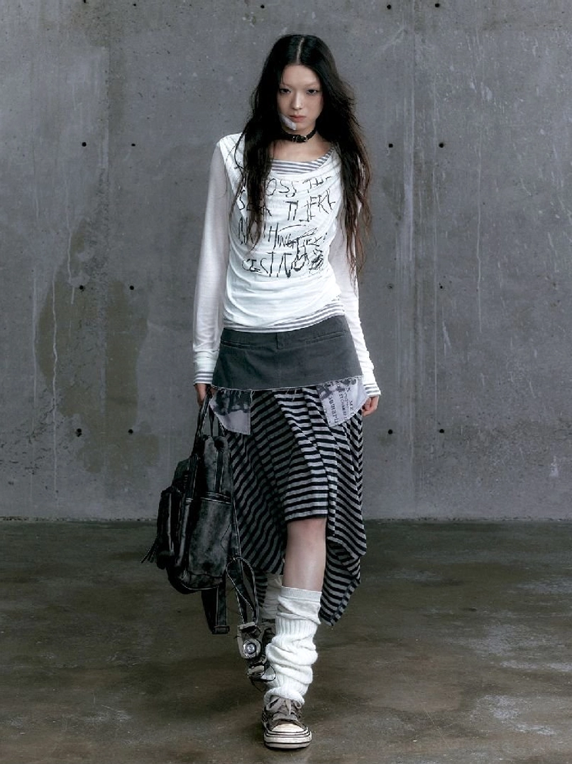 White graffiti layered long sleeve top styled with an asymmetric striped skirt and leg warmers