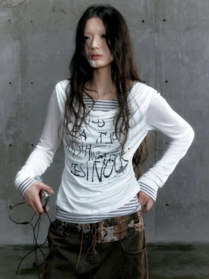 White graffiti layered long sleeve top with striped underlayer and asymmetric draped neckline front view