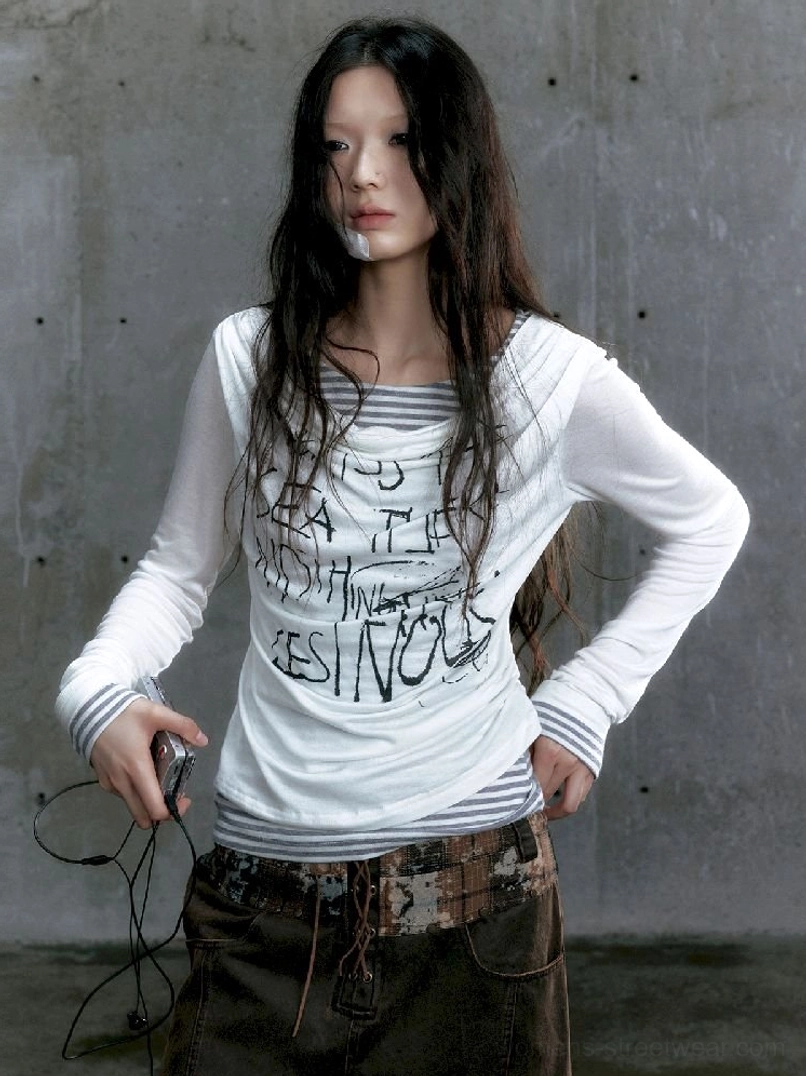 White graffiti layered long sleeve top with striped underlayer and asymmetric draped neckline front view