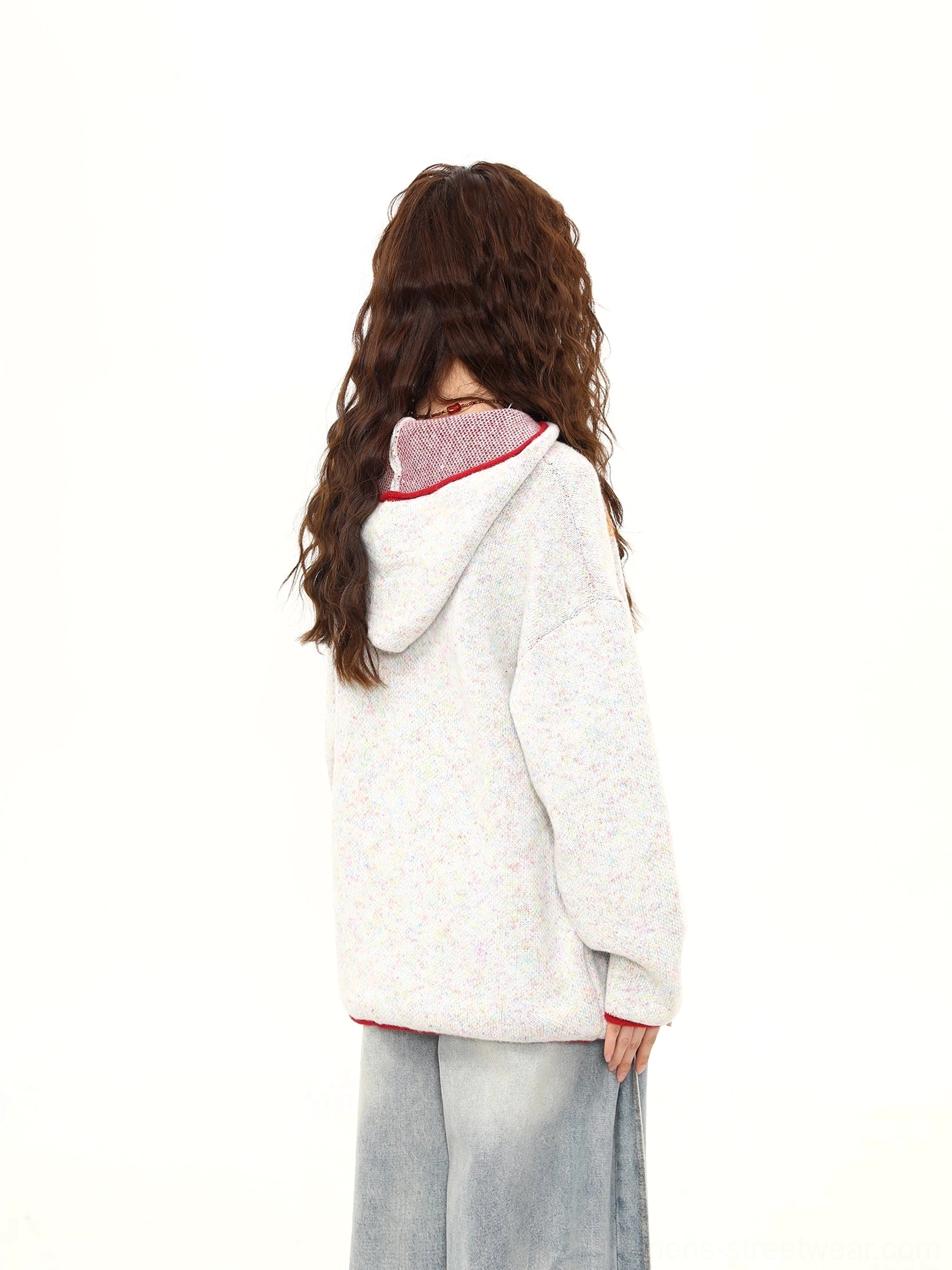 Back view of the white gray oversized knit sweater with red trimmed hood detail and relaxed streetwear silhouette