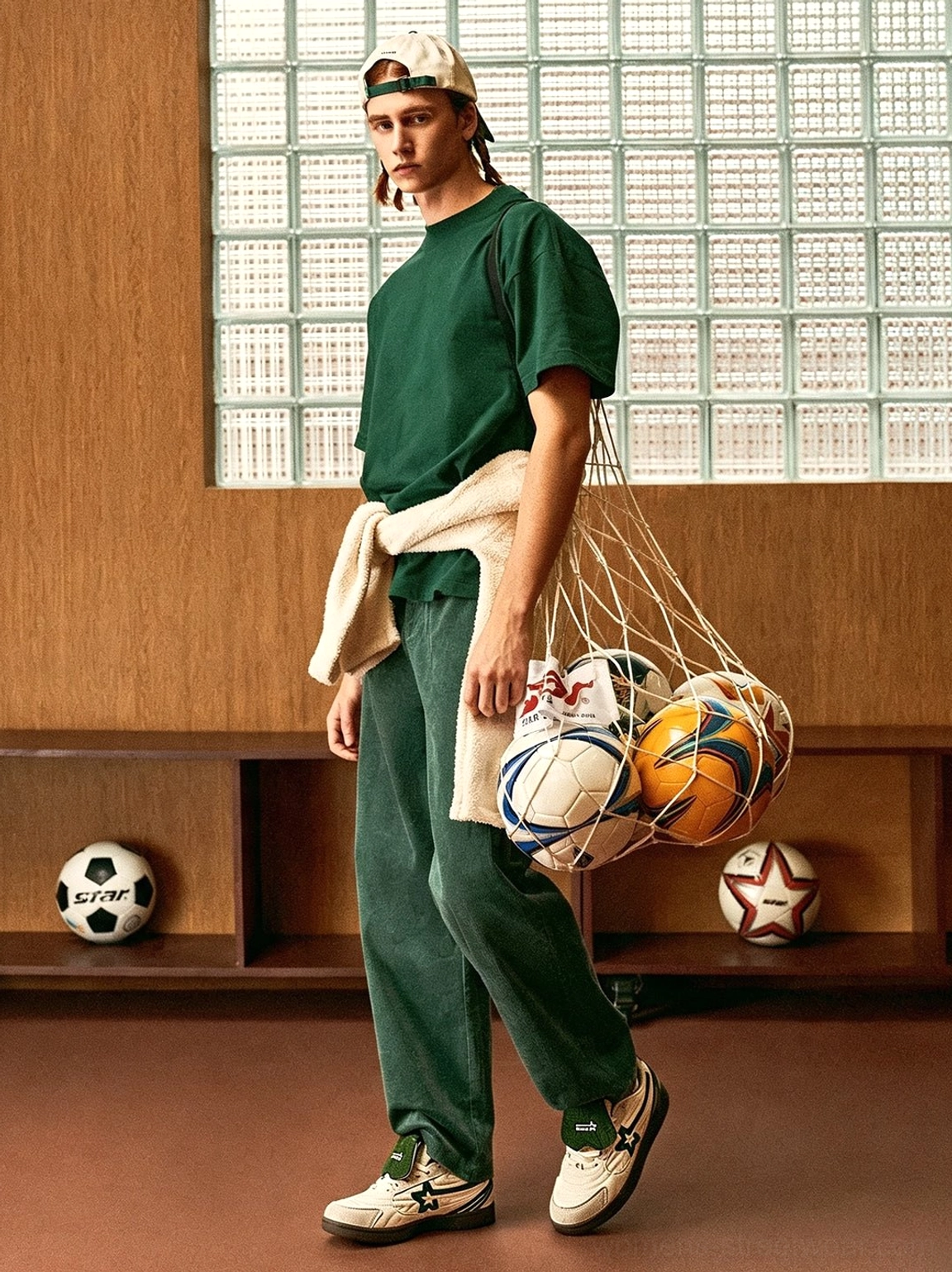 Full body retro sportswear outfit featuring white and green detachable tongue low top sneakers and a sports ball net bag