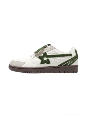 White and green detachable tongue star low top streetwear sneakers shown from a three quarter side view with quilted toe panels layered suede accents and dark brown rubber outsole
