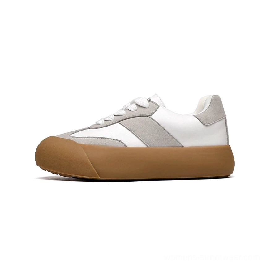 White and grey vintage chunky sneakers with light tan rubber outsole and suede toe cap shown in front three quarter view