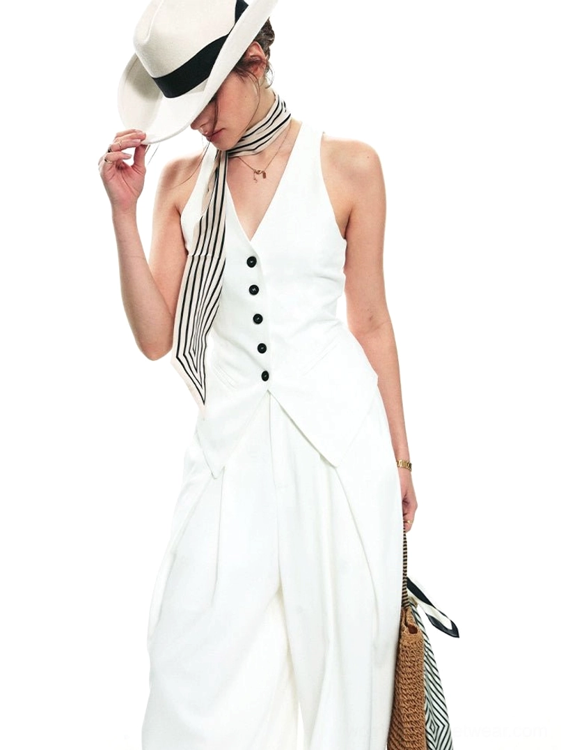 White sleeveless halter waistcoat and wide-leg pants outfit showing asymmetrical hem and decorative front buttons
