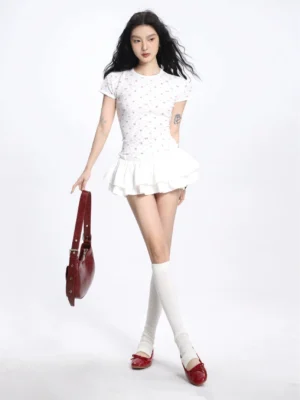 White high waisted ruffle mini skirt styled with a cropped floral top, over the knee socks, red loafers, and a burgundy shoulder bag in a Korean streetwear outfit