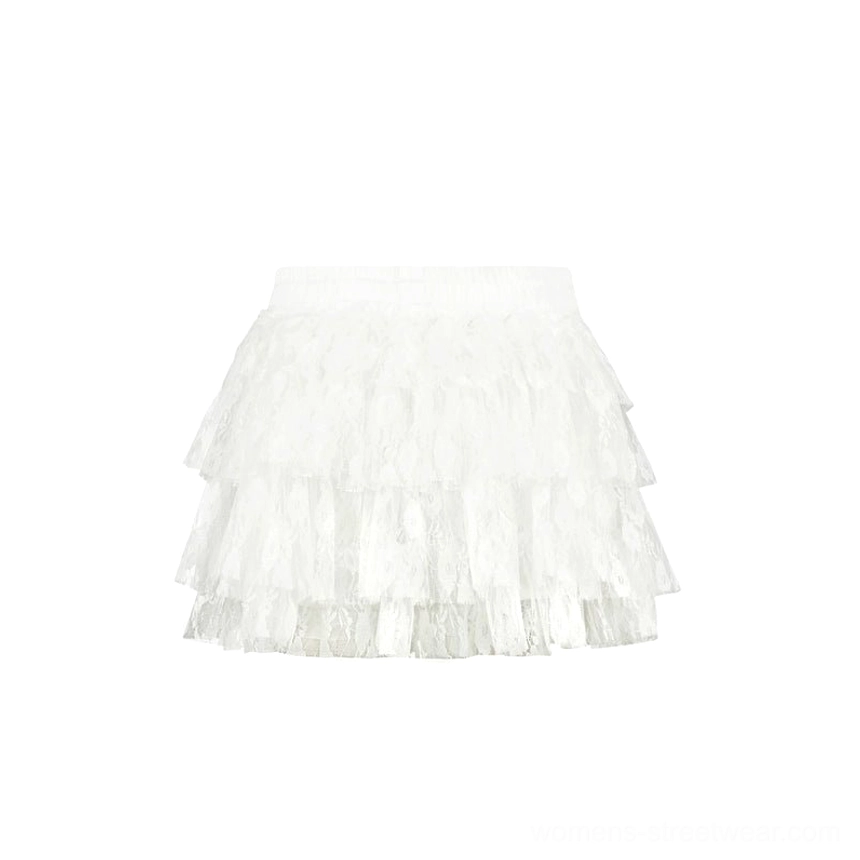 White high-waisted tiered tulle mini skirt displayed in a flat lay with fluffy cake skirt layers