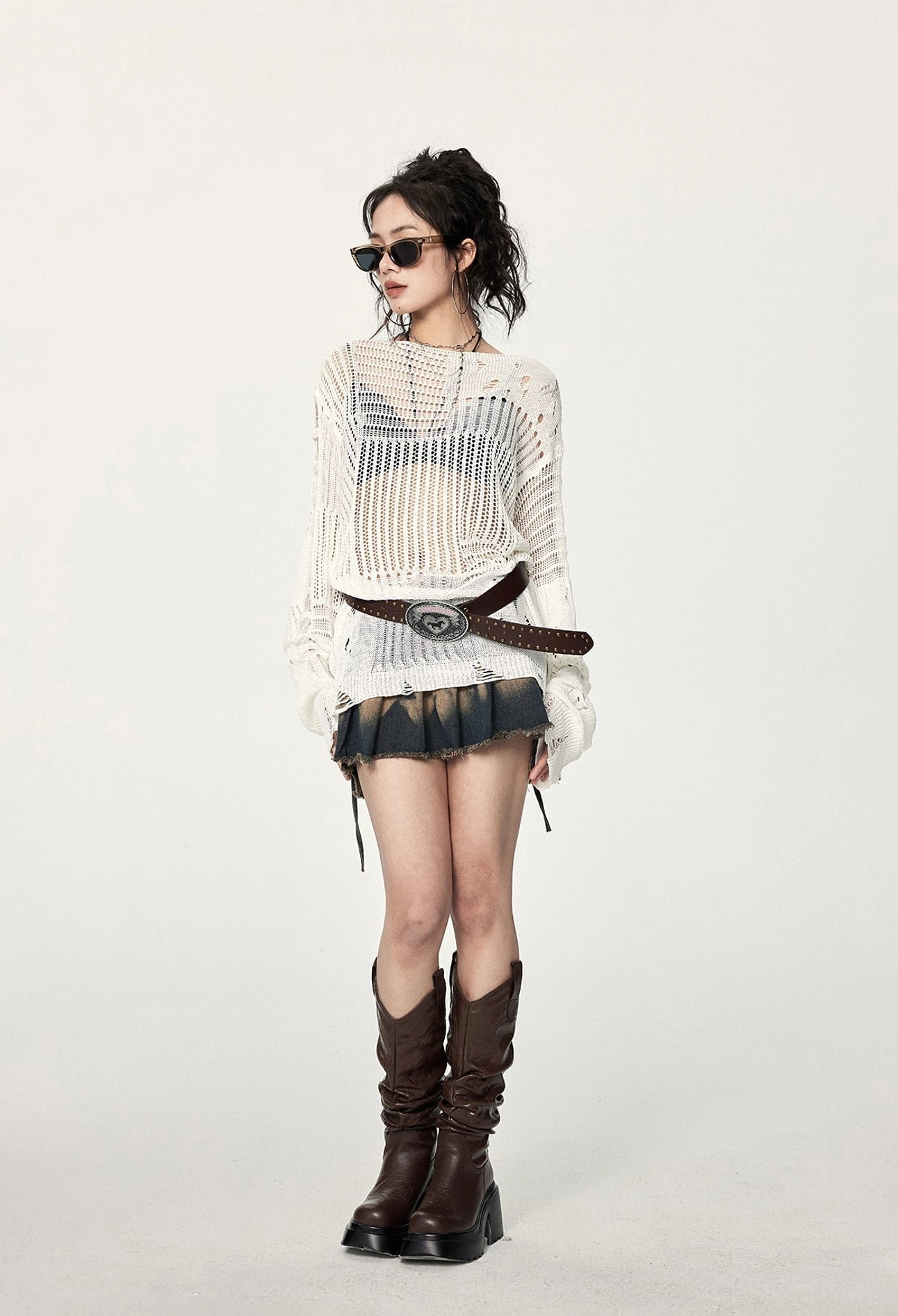 White hollow-out crochet sweater with distressed detailing, loose long-sleeve fit, asymmetric hem, and edgy Y2K streetwear appeal