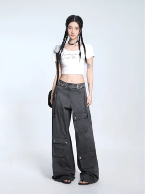 White lace trim graphic baby tee cropped U-neck short sleeve top styled with dark gray wide-leg cargo pants front full body view