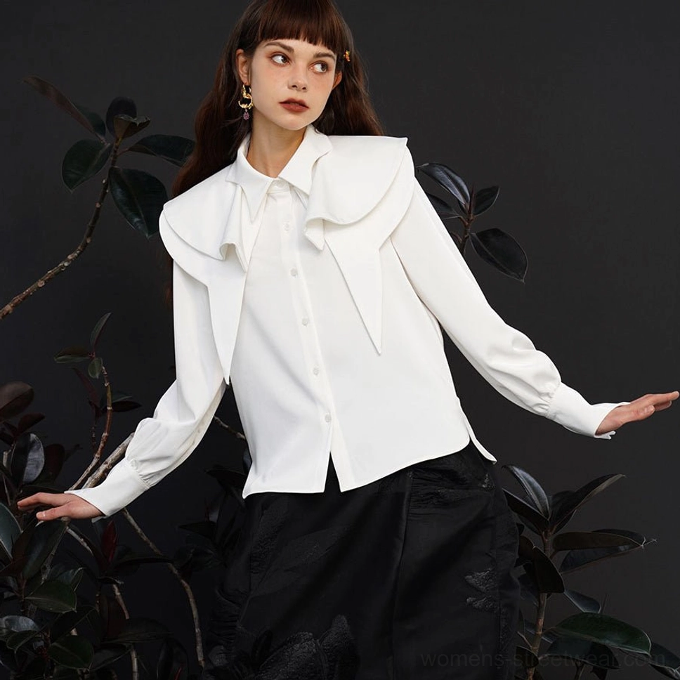 White fox charm ruffle blouse shown from the side with dramatic layered collar and tailored button front