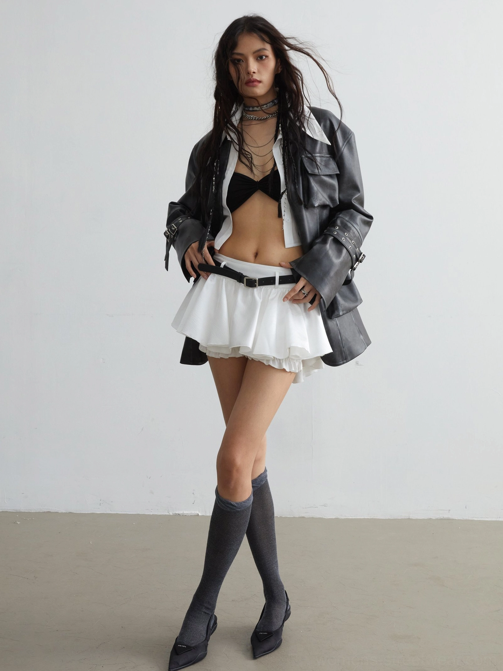 White layered ruffle mini skirt with black belt embellishment Y2K fashion styling view