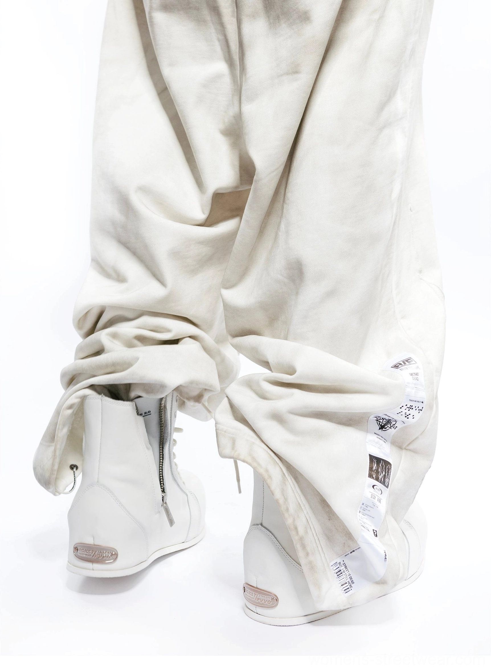 White leather high-top boot rear side detail showing side zipper, smooth leather upper, and metal heel accent