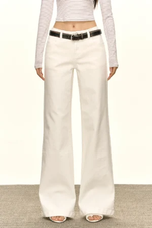 Front view of white low-rise wide-leg jeans styled with a striped cropped top and black belt for a Y2K streetwear outfit