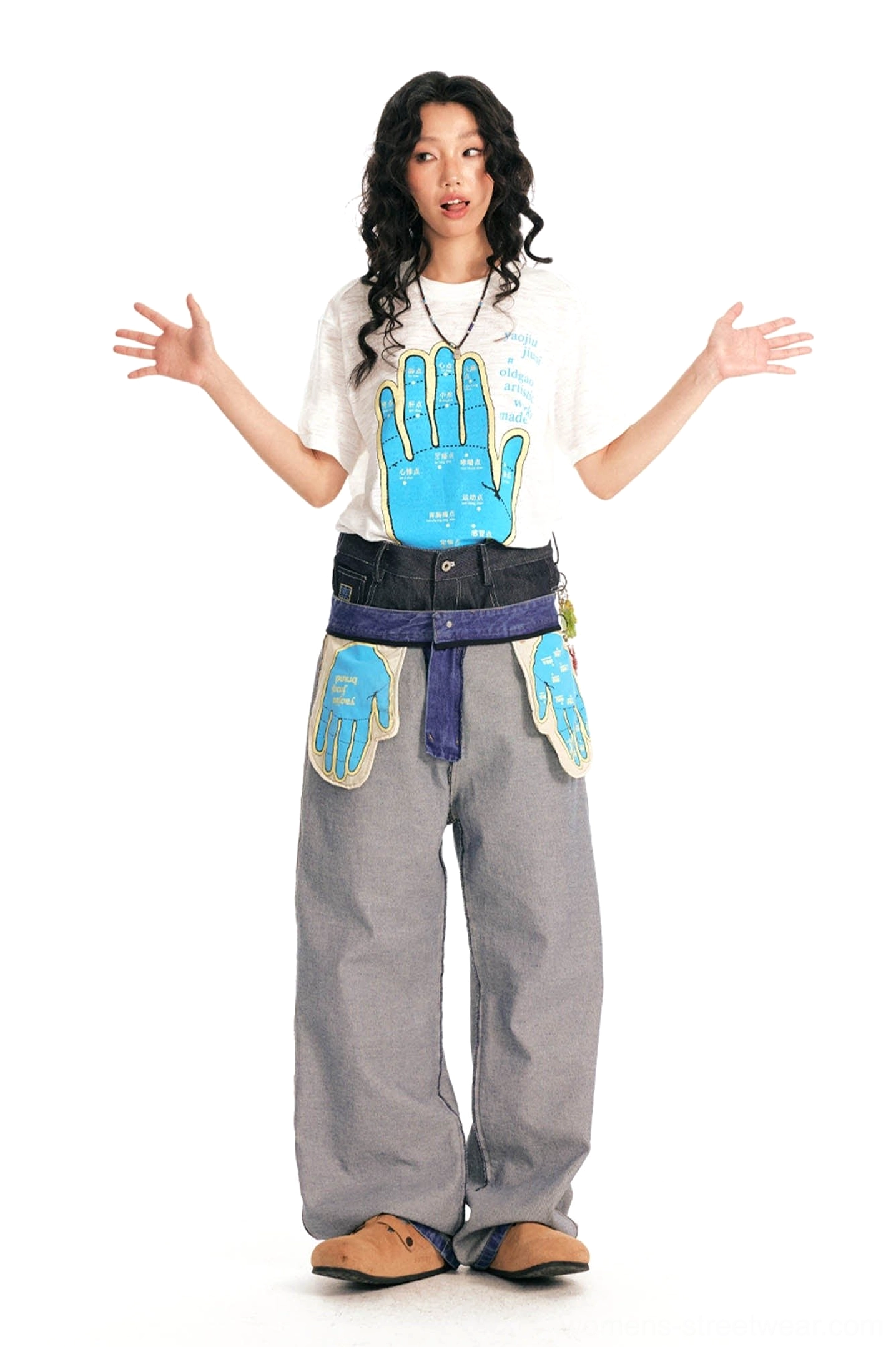 Female model front view in relaxed white hand meridian map graphic t-shirt with blue acupuncture illustration