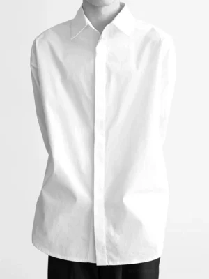 White minimal oversized cotton poplin shirt with pointed collar and concealed button placket front close-up