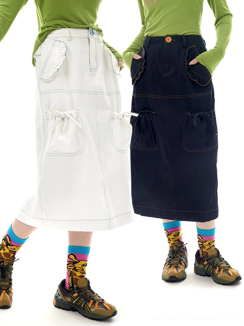 White and navy denim utility pocket midi skirts styled on models with green tops graphic socks and hiking shoes
