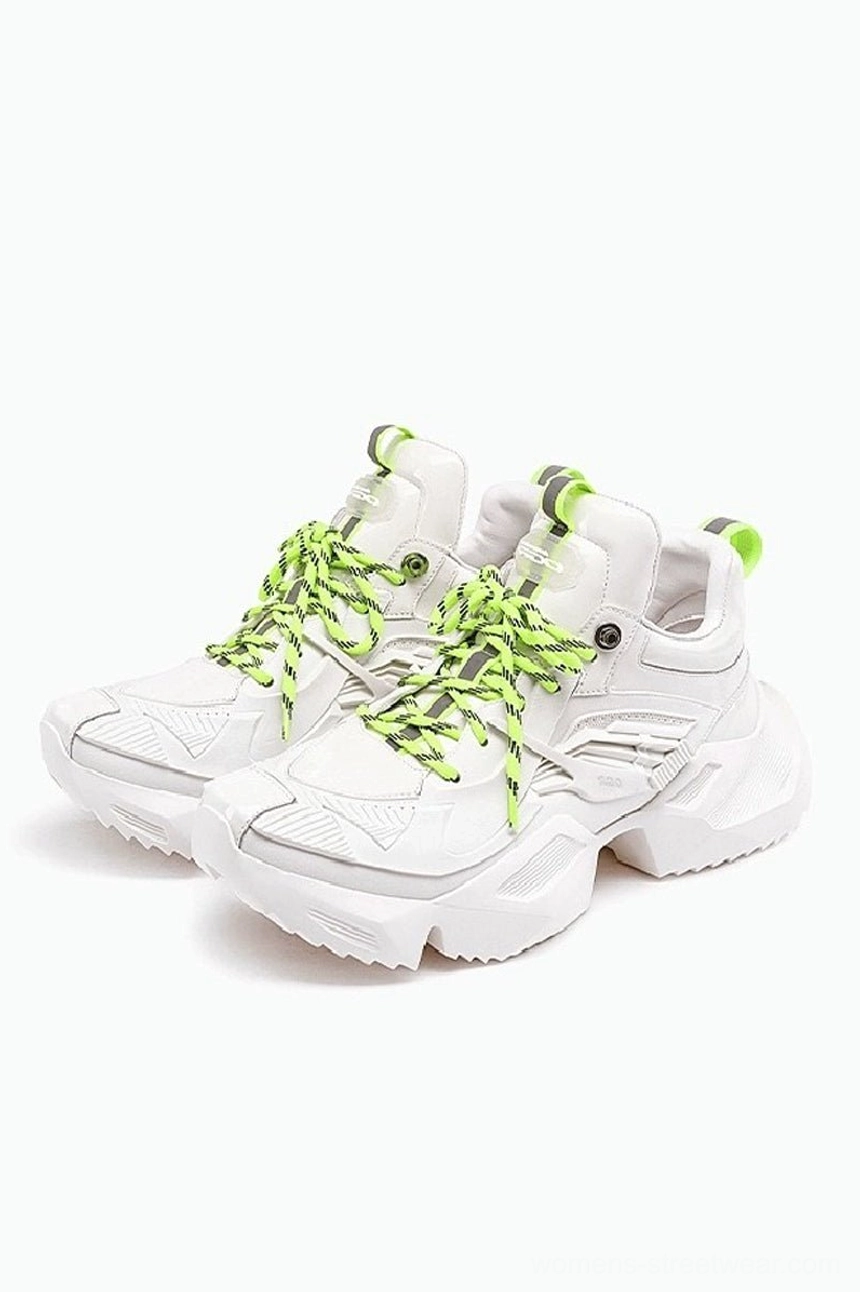 White and neon green 3D-printed platform sneakers shown as a paired front oblique view with geometric uppers, striped laces, bright heel pull tabs, and thick jagged streetwear outsoles