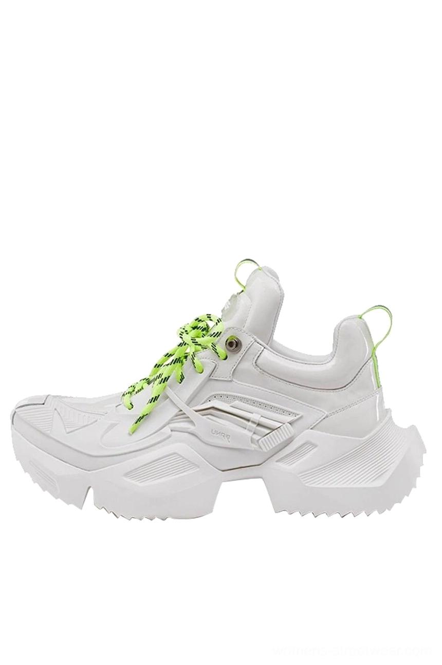White and neon green futuristic platform sneaker shown from the right side with a geometric 3D-printed-style upper, lace-up closure, and sculpted chunky jagged sole